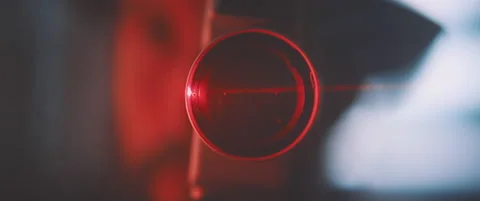 Close up into vintage camera lens in red laser light Stock Footage 203562393
