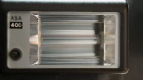 Close-Up of a Vintage Clip-On Camera Flash with Xenon Tube and Fresnel Diffuser Stock-Footage 341898455
