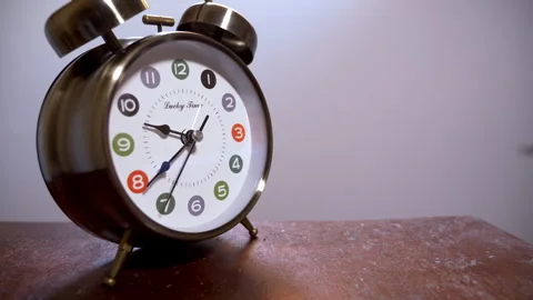 Close-Up of a Vintage Clock on a Table Against a White Wall Stock Footage 337384927