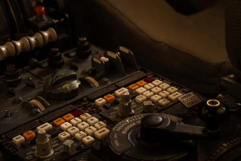 Close-up of a vintage control panel with numerous buttons and dials, evokin.. Stock Photos