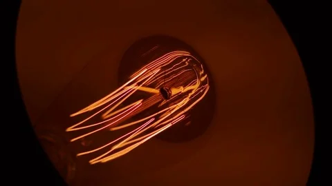 Close-up on a vintage Edison light bulb inside table lamp Video stock 85340542