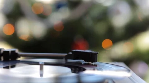 Close up: Vintage gramophone play back vinyl plate. Background: Christmas tree. Stock Footage 70796548
