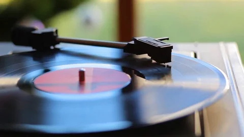 Close up: Vintage gramophone play back vinyl plate. Background: Christmas tree. Stock Footage 70797956