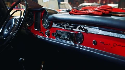 Close-up of vintage red car dashboard panel in showroom Warsaw Stock-Footage 340879951