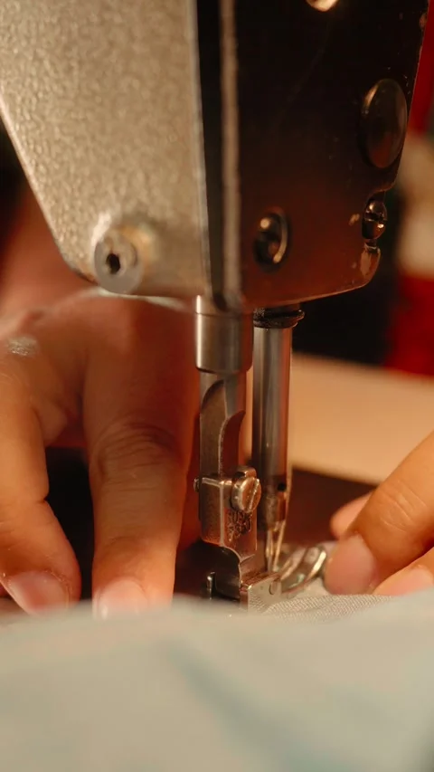 Close-Up of Vintage Sewing Machine Needle Stitching Light-Colored Fabric Stock Footage 341908661