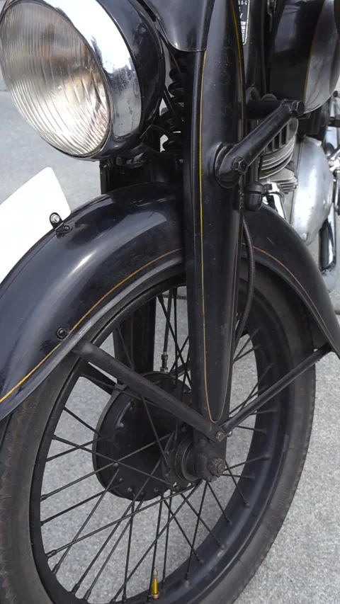 Close up of a vintage Triumph motorcycle front wheel and headlight Stock Footage 345261089