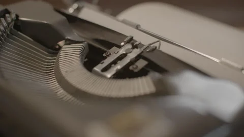 Close-Up of Vintage Typewriter Typebars Striking Paper Stock Footage 344625897