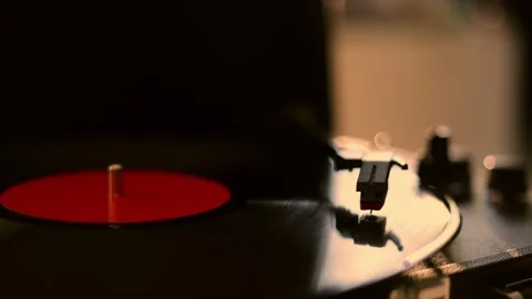 Close-up of a vintage vinyl record player spinning with a red label Stock Footage 337104462
