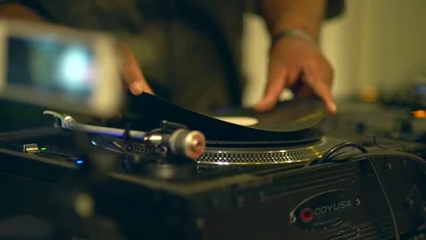 Close up of vinyl disk placing on the modern turntable. DJ is placing vinyl disk Stock-Footage 82710151