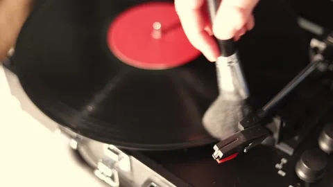 Close-up of a vinyl record being cleaned with a brush on a turntable Stock Footage 337104413