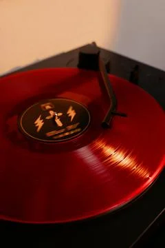 Close up of a vinyl record player with a red record Stock Photos