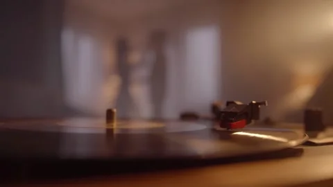 Close-up of vinyl record playing on turntable, romantic couple dancing together Stock Footage 154826463
