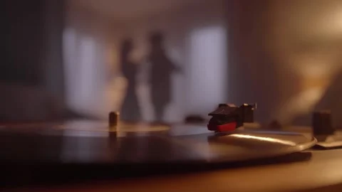 Close-up of vinyl record playing on turntable, romantic couple dancing together Stock Footage 154826493