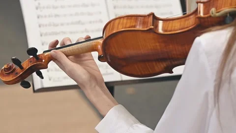 Close-up of violin playing back view Inspiring girl uses violin to create Stock Footage 305543688