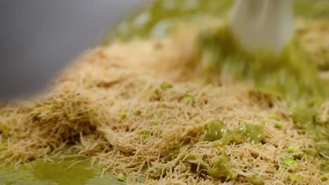 Close Up of Viral Dubai Kunafa Chocolate Filling: Creamy Pistachio Paste Mixed w Stock Footage 337751628
