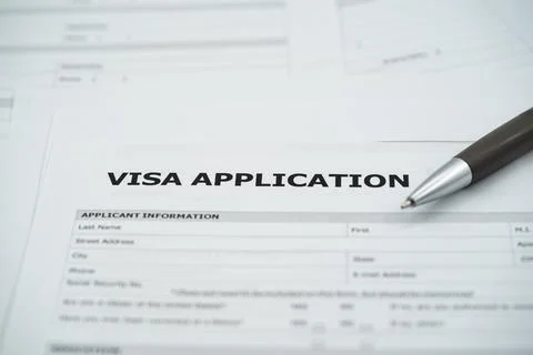 Close up of visa application form with applicant information section and pen Stockfoto's