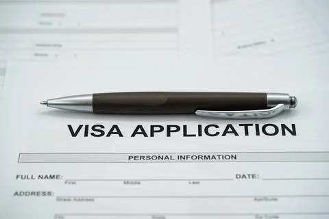 Close up of visa application form with pen on personal information section Stockfoto's