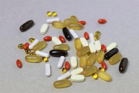 Close-up vitamins on the light gray background, 90 degree angle. Stock Photos
