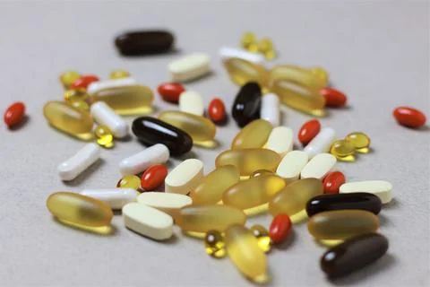 Close-up vitamins on the light gray background, 45 degree angle. Stock Photos
