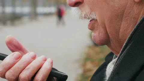 Close-up voice control on a mobile phone. Talking mouth in the speaker of a Stock Footage 143728904