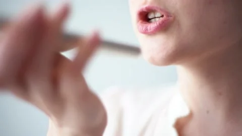 Close-up voice control of a smart home on a mobile phone. Talking mouth in the Stock Footage 130750683