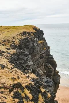 Close up of volcanic cliff and sea. Wild nature. Rock texture background. Nature Stock Photos
