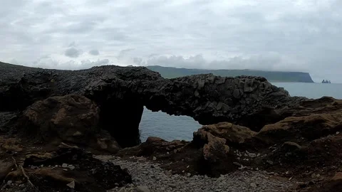 Close-up of volcanic rock arch with Atlantic ocean background, 4K Stock Footage 334571677
