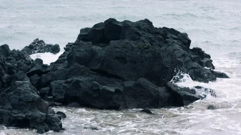 Close up volcanic rocks and ocean waves jeju island south korea Stock Footage 229424418