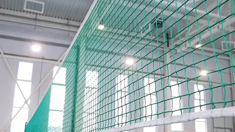 Close-up of a volleyball net stretched in an indoor gym or sports complex. Vidéo 339764688