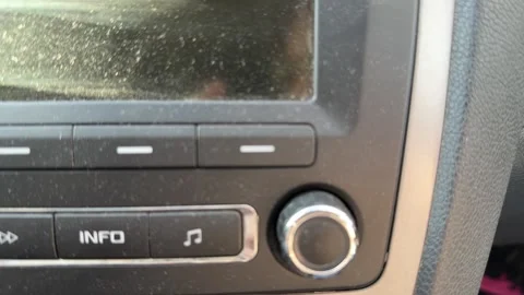 Close-up of volume knob and media buttons on a car stereo, dashboard audio 動画素材 337114776