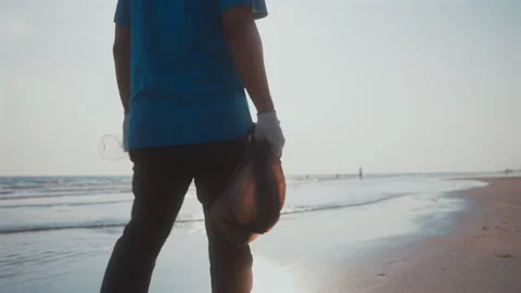 Close up of volunteer with garbage bags cleaning plastic on the beach. Stock Footage 270421753