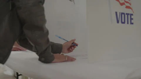 Close Up of Voter Casting Votes Behind Privacy Box at Polling Station Stock Footage 219563293