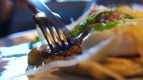 Close-up, waffle, pancake with bacon, egg, man holds fork and knife, cuts piece Stock Footage 139437504