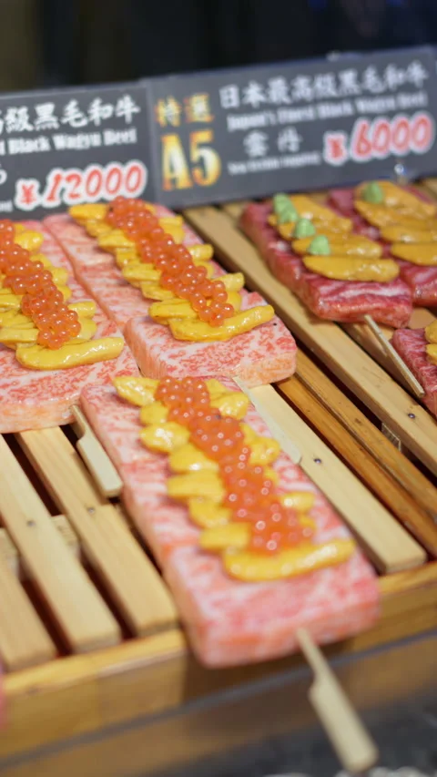 Close up of Wagyu beef with different toppings on skewers at the Tsukiji Fish Stock Footage 309666379