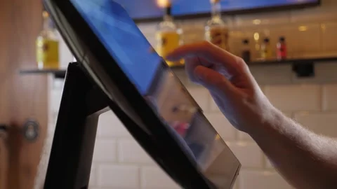 A close-up of a waiter or bartender working at a computer in a cafe. Video stock 287583405