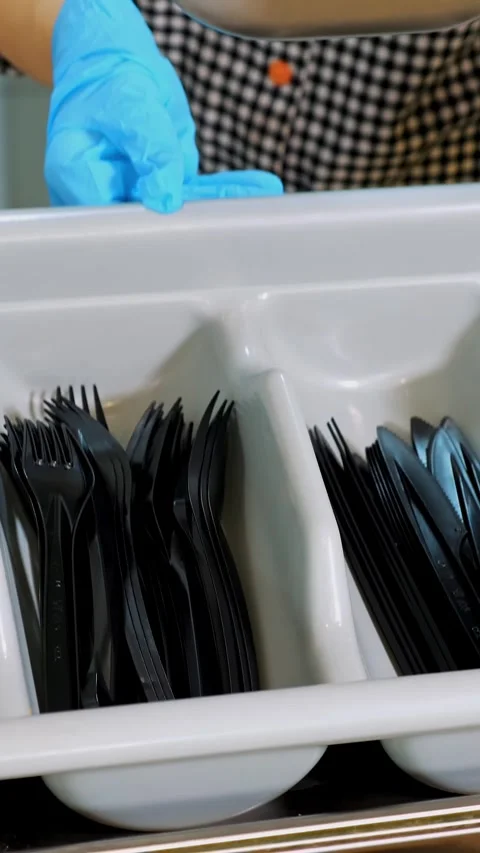 Close-up. the waiter, in protective gloves, puts a tray with disposable cutlery, Stock Footage 322713595