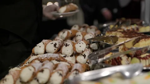Close up of waiter’s hand serving Italian cannolis  Stock Footage 144123070