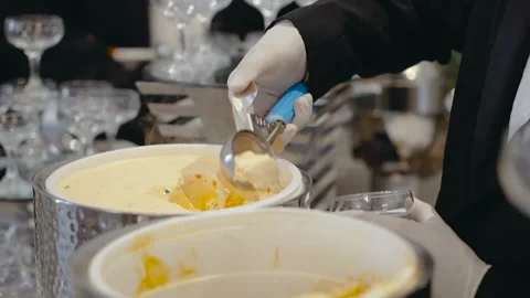 Close-up of waiter's hands in white gloves with ball of ice cream Stock Footage 172212031