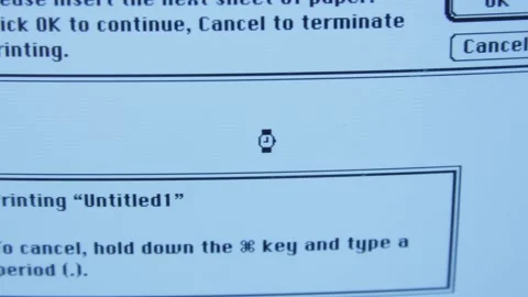 Close up on waiting watch clock icon on old apple computer Stock Footage 131338770