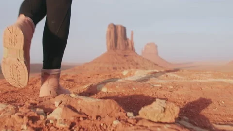 Close up walking shoes slow motion with cinematic wilderness desert background 스톡 동영상 157527952