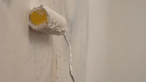 A close-up of a wall being painted white with a roller. Apartment painting,.. Stock Footage 337951820