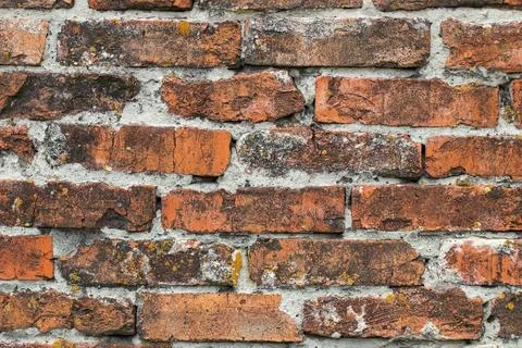 Close-up of the wall with bricks blackened by time. Stock Photos
