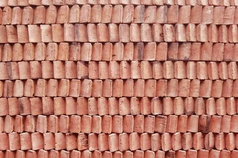 Close up of wall clay stack of red clay bricks in rows Stock Photos