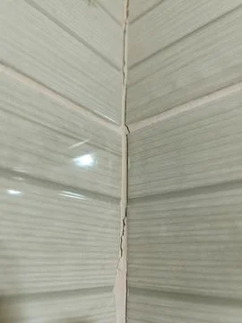 A close up of a wall with a crack in it Stock Photos