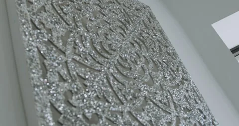 Close-up of wall decor: a silver crystal artwork with a pattern. 스톡 동영상 323023304
