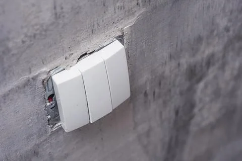 Close-Up of a wall light switch installed during renovation. Light switch mou Stock Photos