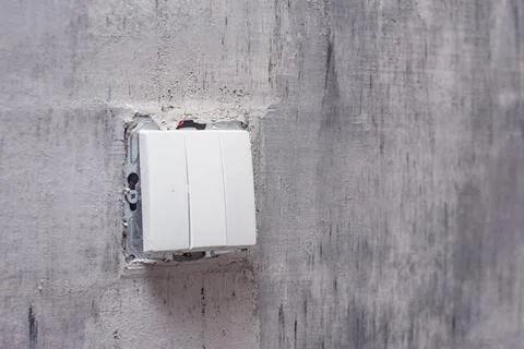 Close-Up of a wall light switch installed during renovation. Light switch mou Stock Photos