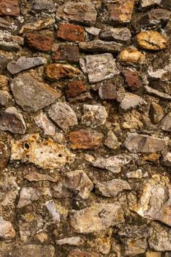 A close up of a wall made of large rocks and cement, great for a background or Stock Photos