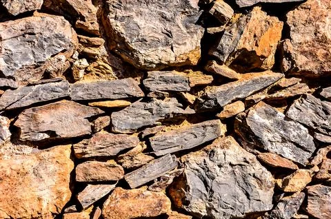 A close up of a wall made of rocks Stock Photos