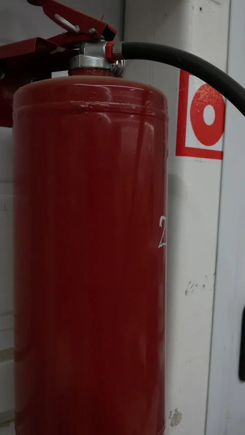 Close up of wall mounted fire alarm and Fire Extinguisher. Red fire extinguisher Stock Footage 297733806